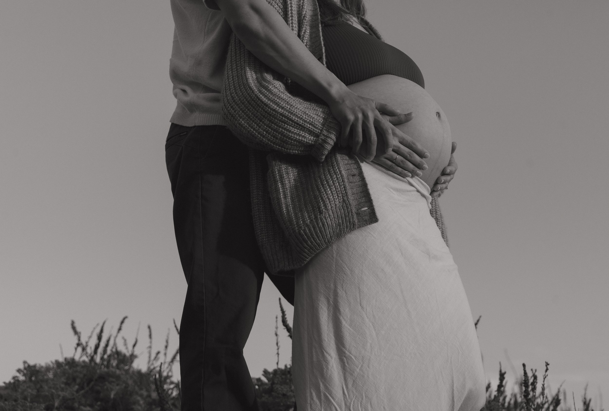 An expecting couple on the coast